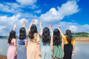 group of friends - hands lifted towards the sky