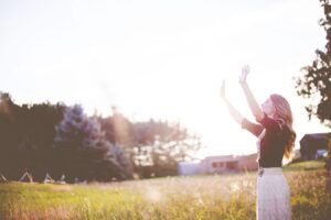 woman praying with outstretched hands