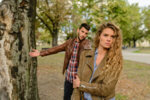 man trying to reach for a woman who looks upset