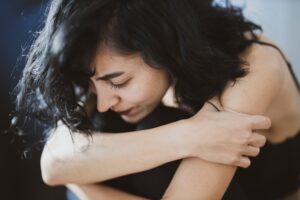 bible verses about forgiveness - woman embracing herself