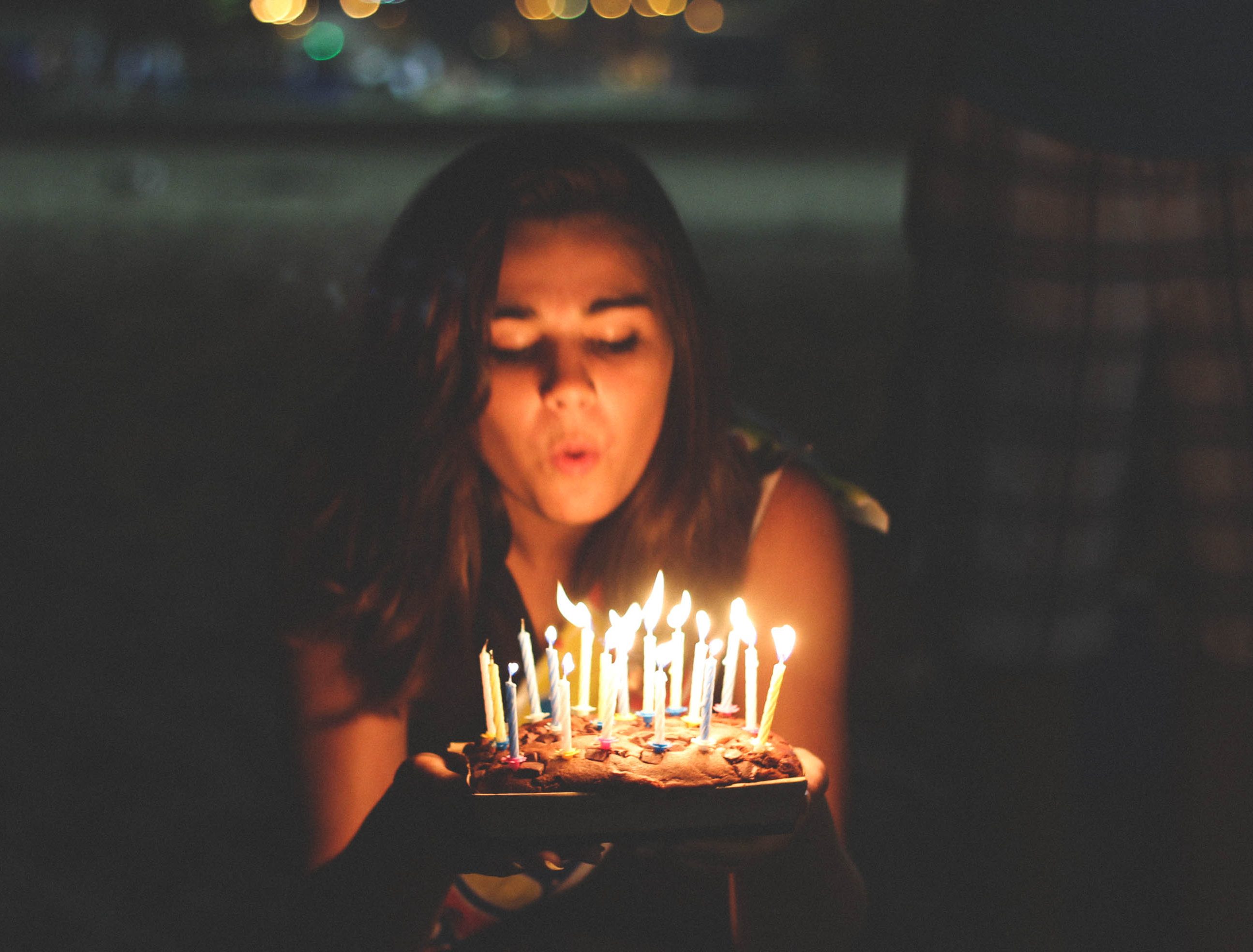 Girl blowing her birthday cake