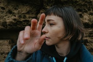 woman looking away while stretching her hands