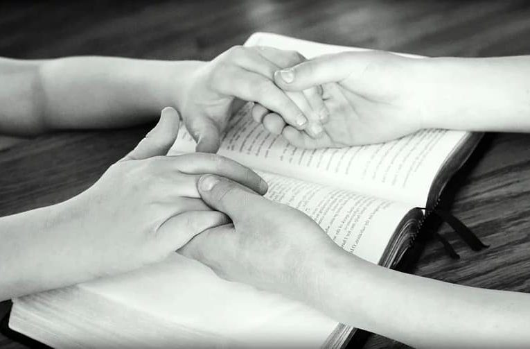 two people joining hands for prayer, Bible verses about prayer