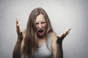 woman screaming with her hands raised