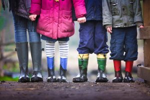 four children wearing boots