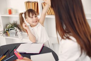 little girl raising her hand