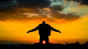 silhouette of a man spreading his arms