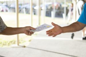 person handing card to another