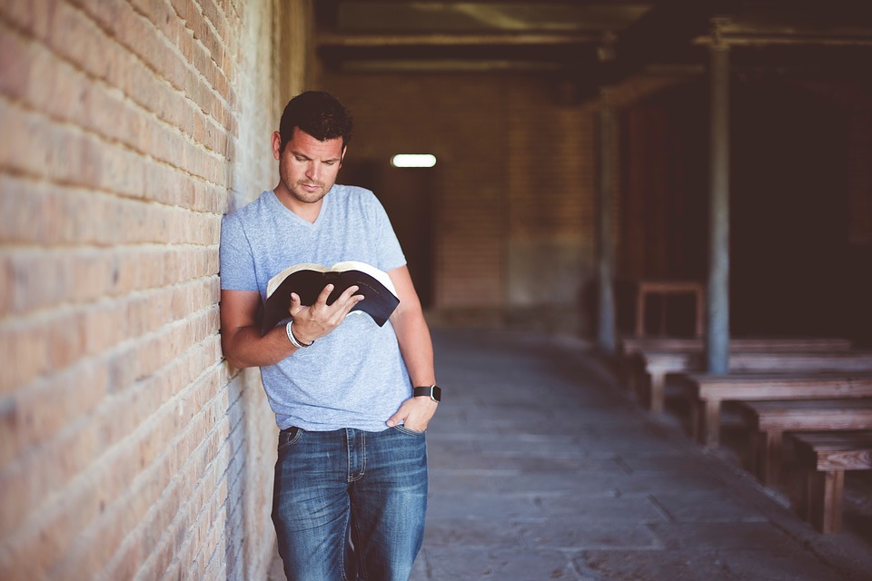 man reading Bible