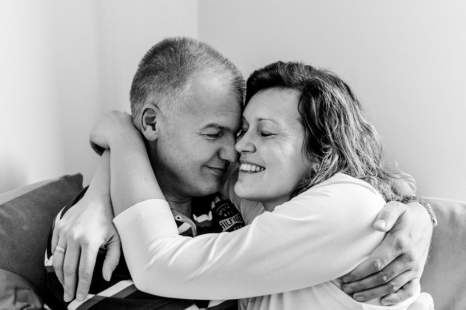 man and woman hugging each other