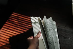 person holding white papers