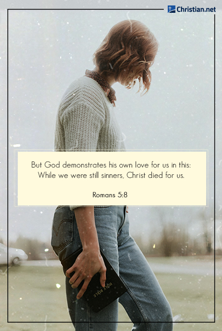 woman with wavy hair wearing a sweater and jeans, holding the bible, bible verses for loving yourself