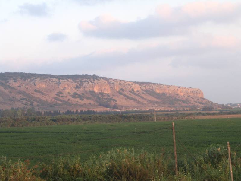 photo of the southwest face of mount carmel, green grassy field, mountains in the bible