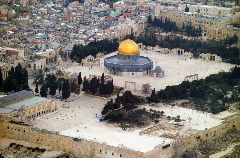 aerial view of the temple mount on mount moriah, temple with gold roofing surrounded by trees and other buildings
