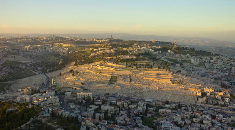 aerial shot of mount of olives, golden sun rays on buildings, mountains in the bible