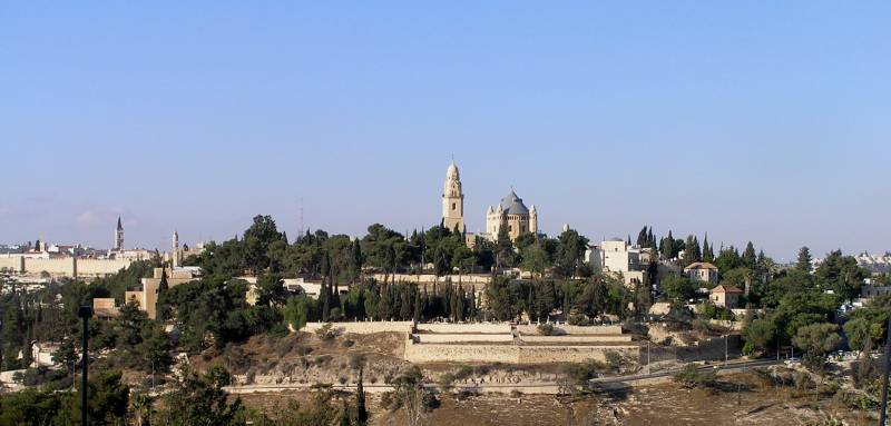 view of the peak of mount zion, blue sky, tall tower