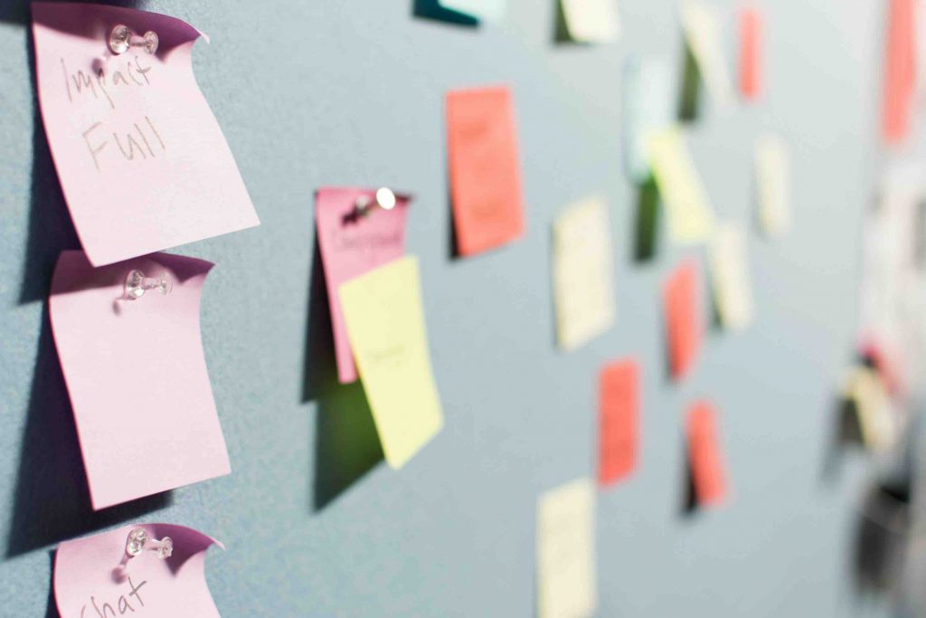 a notice board filled with colorful sticky notes 