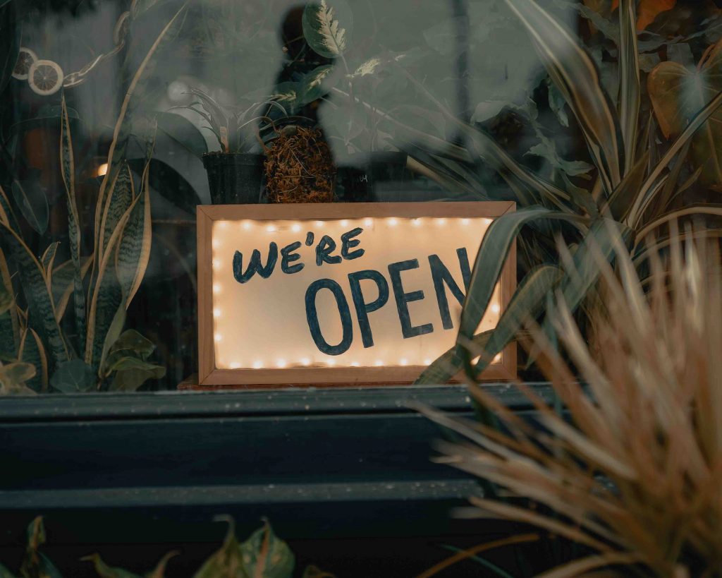 a "we're open" sign by the window